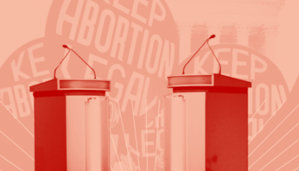 Two debate podiums are placed in front of a pink background with protest signs reading Keep Abortion Legal